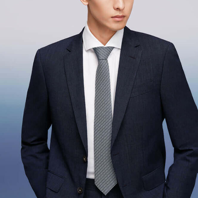 Modern man wearing an exquisite silk tie and a sharp business suit, epitomizing elegance and professionalism.