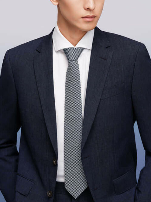 Modern man wearing an exquisite silk tie and a sharp business suit, epitomizing elegance and professionalism.