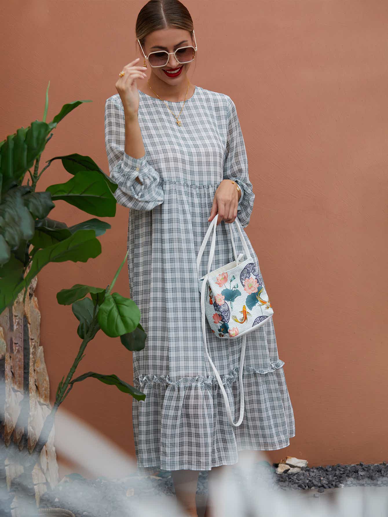 White canvas crossbody bag with The Lotus Gatherers design, placed in a serene outdoor setting, highlighting its eco-conscious and artistic features.