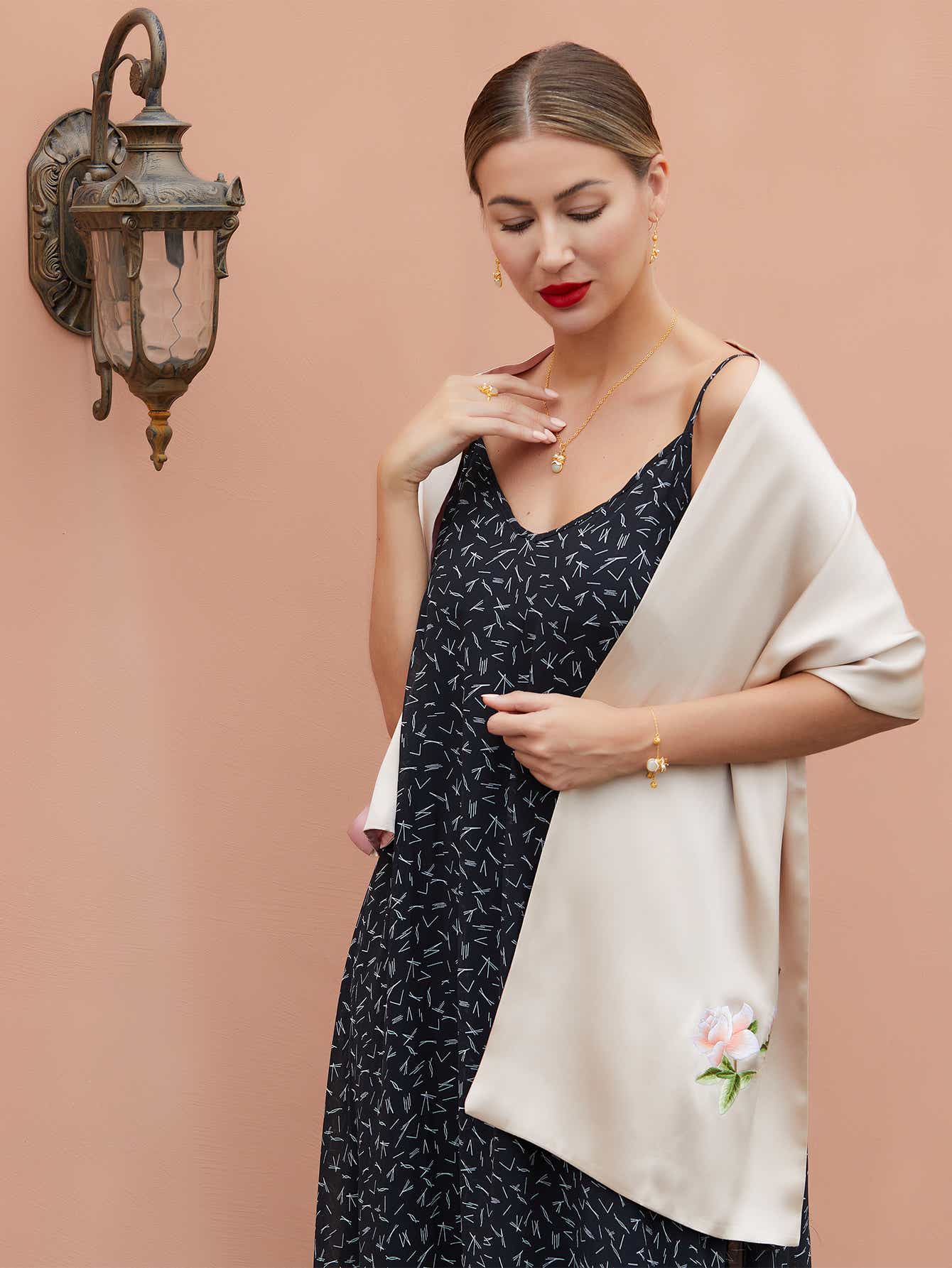 Champagne-pink silk scarf with hand-embroidered orange blossoms, highlighting the rich textures and vivid details of Suzhou silk embroidery.