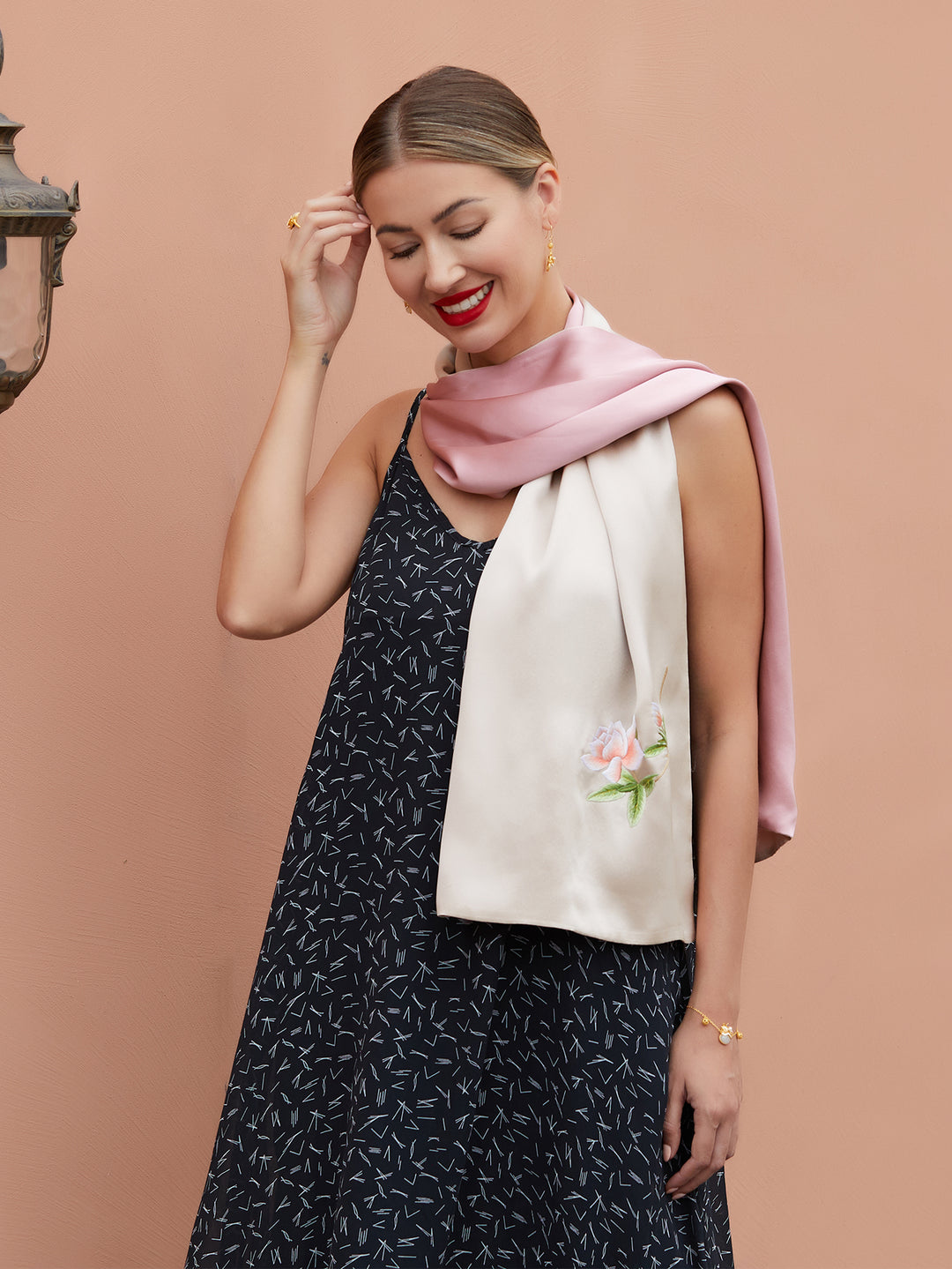 Delicate orange blossom embroidery on luxurious champagne-pink silk scarf, an elegant representation of traditional Suzhou craftsmanship.