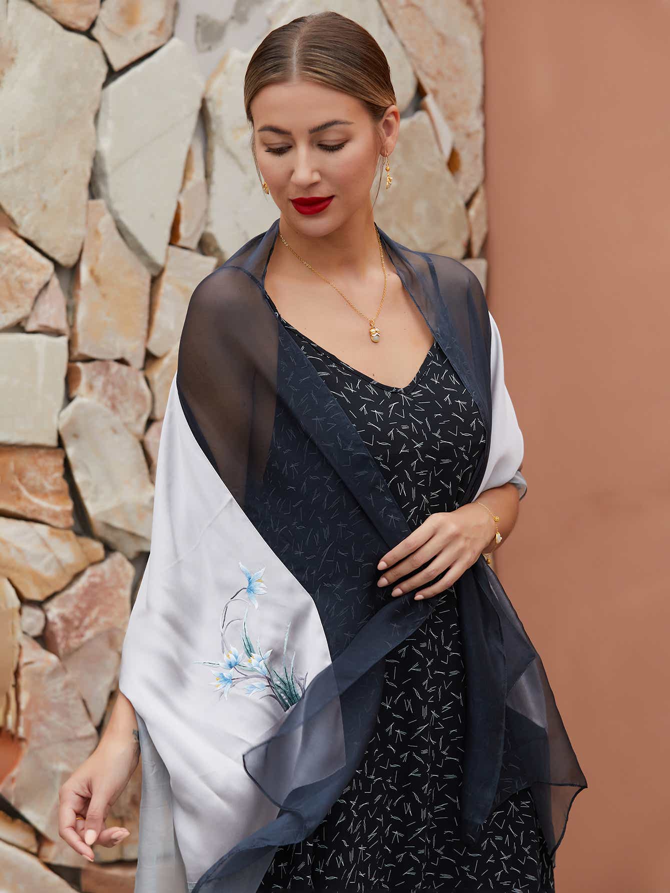 Elegant gray-black mulberry silk scarf with hand-embroidered orchids, showcasing exquisite craftsmanship and a luxurious sheen.