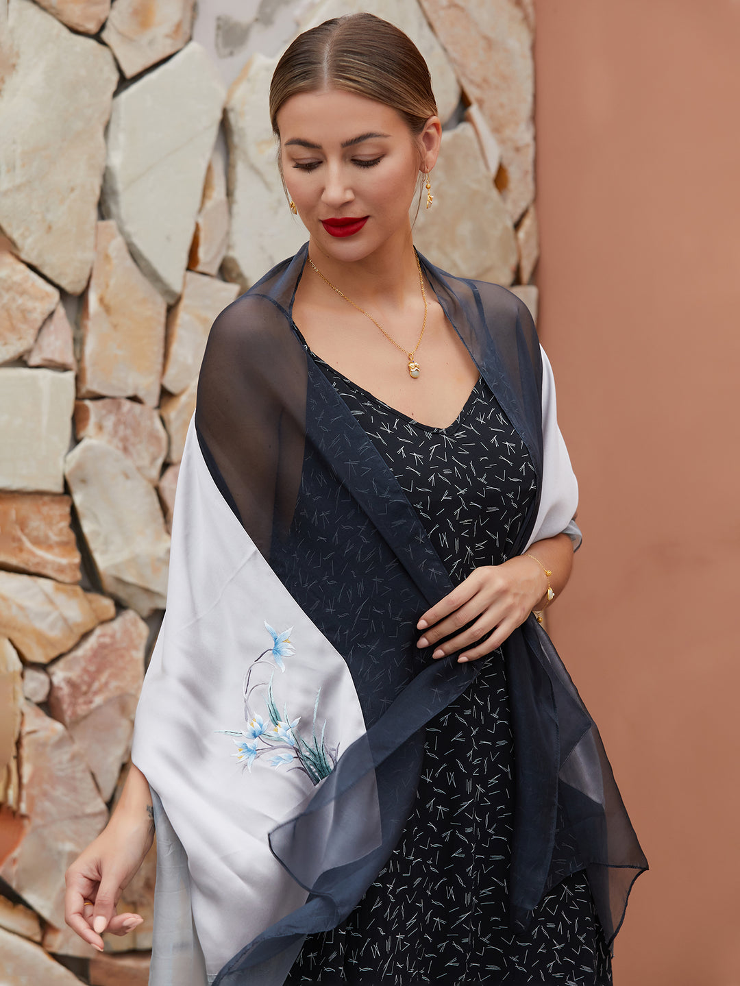 Elegant gray-black mulberry silk scarf with hand-embroidered orchids, showcasing exquisite craftsmanship and a luxurious sheen.