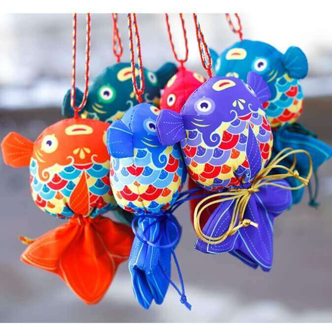 Colorful handcrafted koi fish sachets featuring intricate designs, symbolizing prosperity and offering health benefits through herbal fillings.