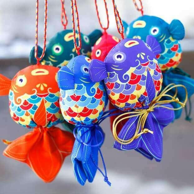 Colorful handcrafted koi fish sachets featuring intricate designs, symbolizing prosperity and offering health benefits through herbal fillings.