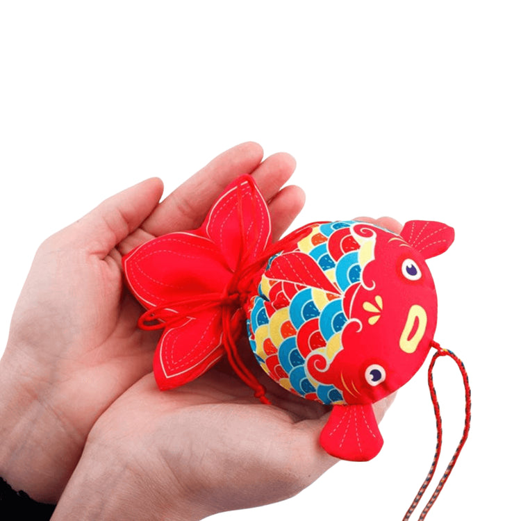 Handcrafted Koi Fish Sachet in vibrant colors held in hands, symbolizing prosperity and success with medicinal herbal filling.