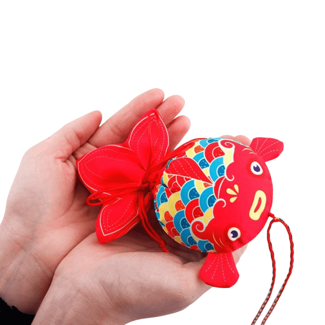 Handcrafted Koi Fish Sachet in vibrant colors held in hands, symbolizing prosperity and success with medicinal herbal filling.