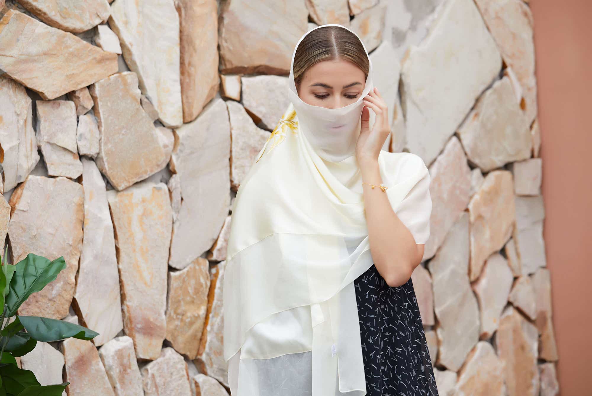 Magnolia flower embroidery on a pure white mulberry silk scarf, ideal for winter warmth and summer coolness with breathable silk.