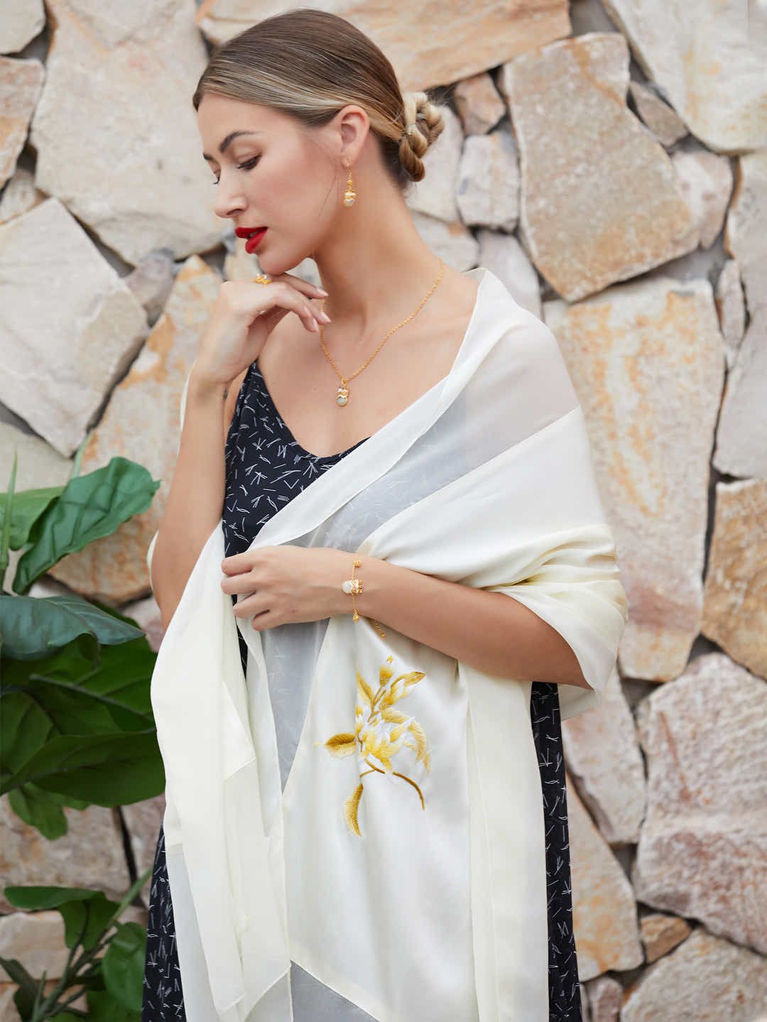 Model wearing the white silk scarf with magnolia embroidery, adding cultural elegance and sophistication to a stylish look.