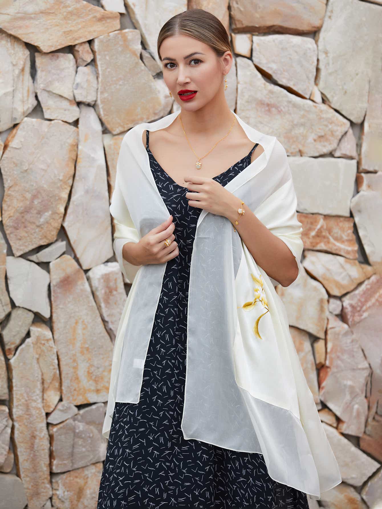 Pure white mulberry silk scarf with hand-embroidered magnolia blossoms, symbolizing purity and nobility in intricate Su embroidery.