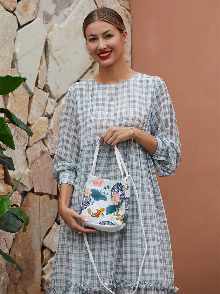 White canvas eco-friendly crossbody bag with hand-dyed The Lotus Gatherers design, combining traditional Chinese art with sustainable fashion.