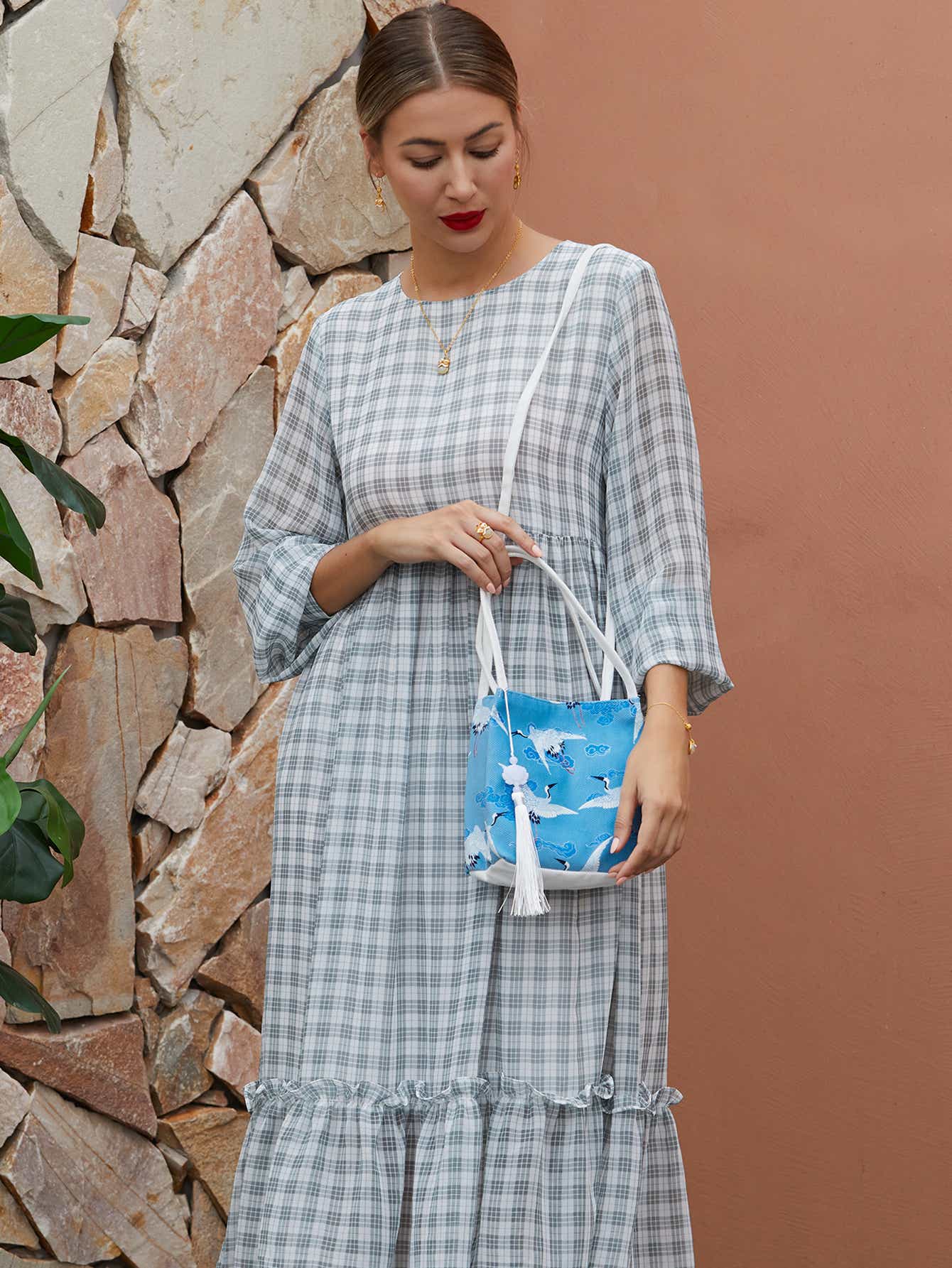 Detailed shot of blue canvas crossbody bag with crane design, featuring high-quality zippers and a sustainable, eco-conscious approach.