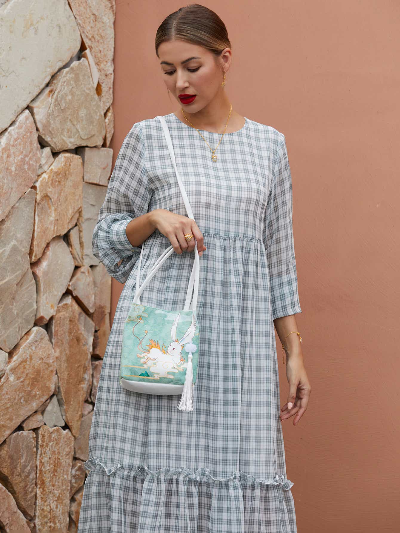 Side view of green canvas eco-friendly crossbody bag with The Jade Rabbit design, showing sleek profile and adjustable strap for comfortable wear.