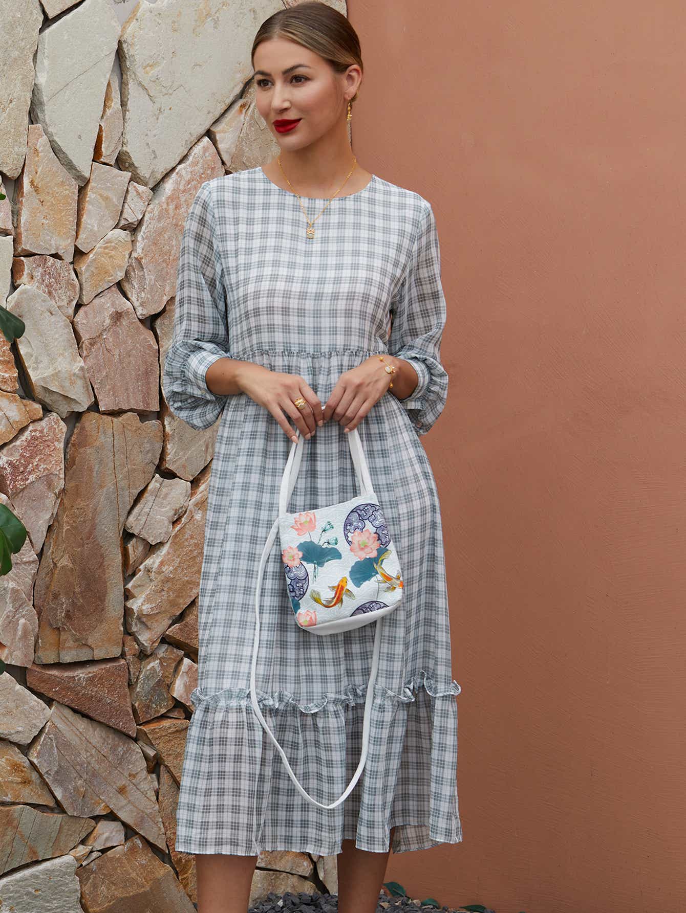 Detailed shot of white canvas crossbody bag with The Lotus Gatherers design, featuring high-quality zippers and sustainable craftsmanship.