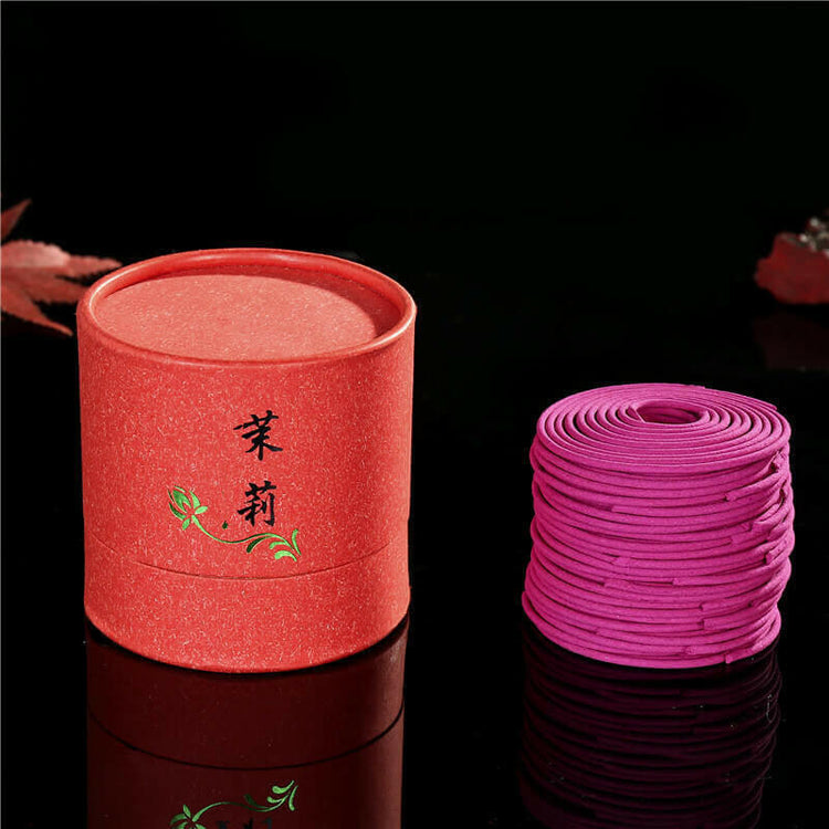 Chinese incense package with coiled incense sticks against a dark background