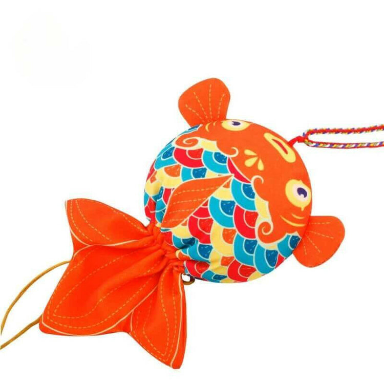 Handcrafted colorful koi fish sachet symbolizing prosperity, filled with medicinal herbs for health benefits.